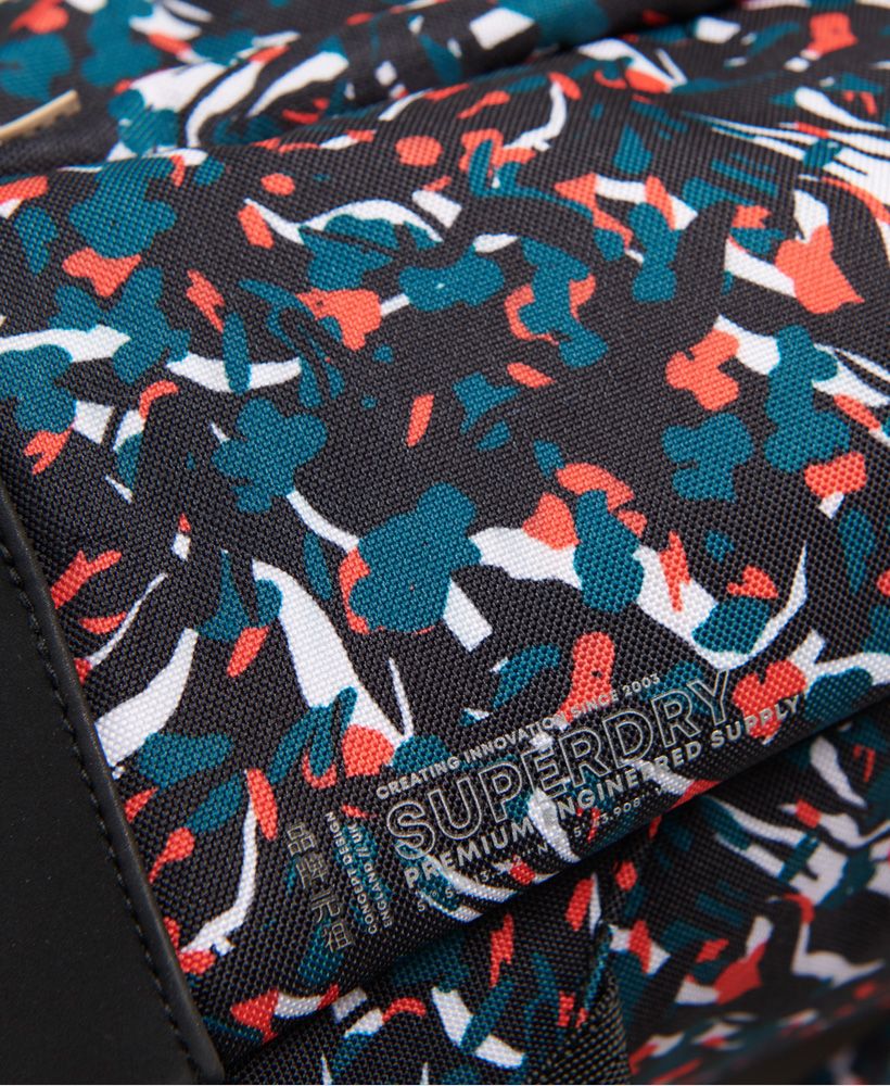 Superdry Women's Urban all over print backpack. This all over print backpack features a main zip compartment with laptop sleeve, a front zip pocket, a back sleeve pocket with hook and loop fastening, a grab handle, adjustable back straps and a soft bottom. Finished with Superdry branding to one side and a Superdry log tab with Japanese characters to the front pocket.H x 36cm D x 13cm W x 25 cm
