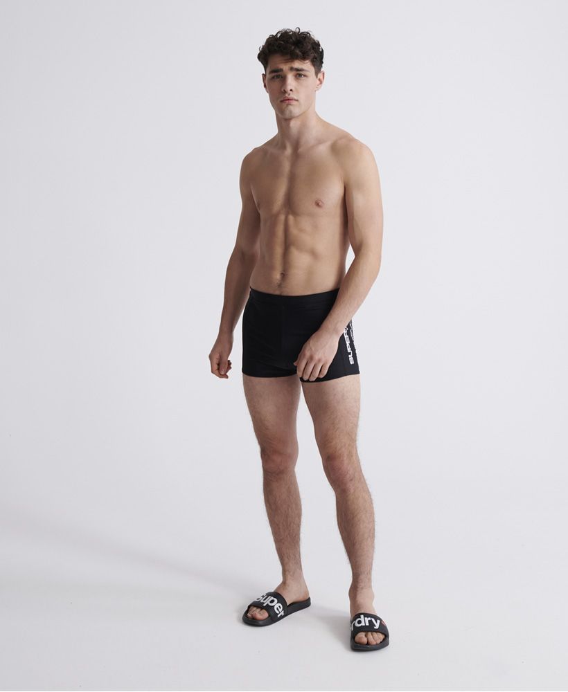 Superdry men's SwimSport midi shorts. Part of our Superdry Swim range these midi swim shorts feature a drawstring waist for the perfect fit. Finished with a Superdry Logo on the front and Superdry branded drawstring.