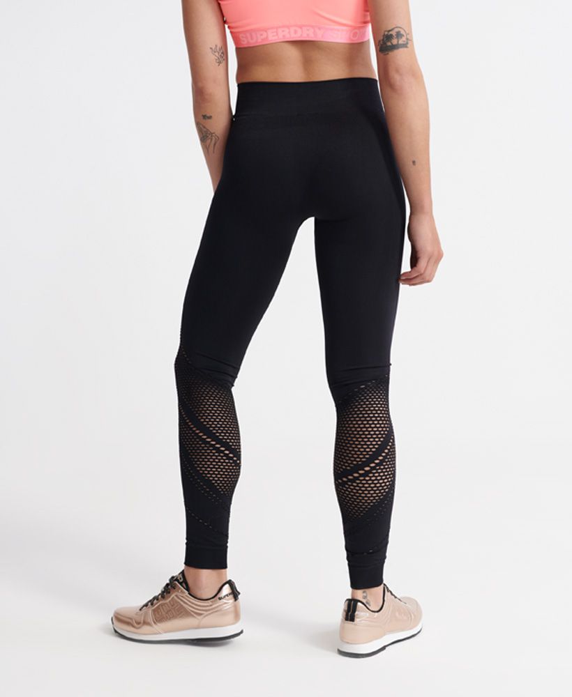 Superdry women's Studio seamless sports leggings. Mix up your workout wardrobe with these stylish four way stretch leggings featuring a cut out design throughout. These leggings are finished with a Superdry logo under the elasticated waistband.Fitted: A body sculpting fit, tight to the body