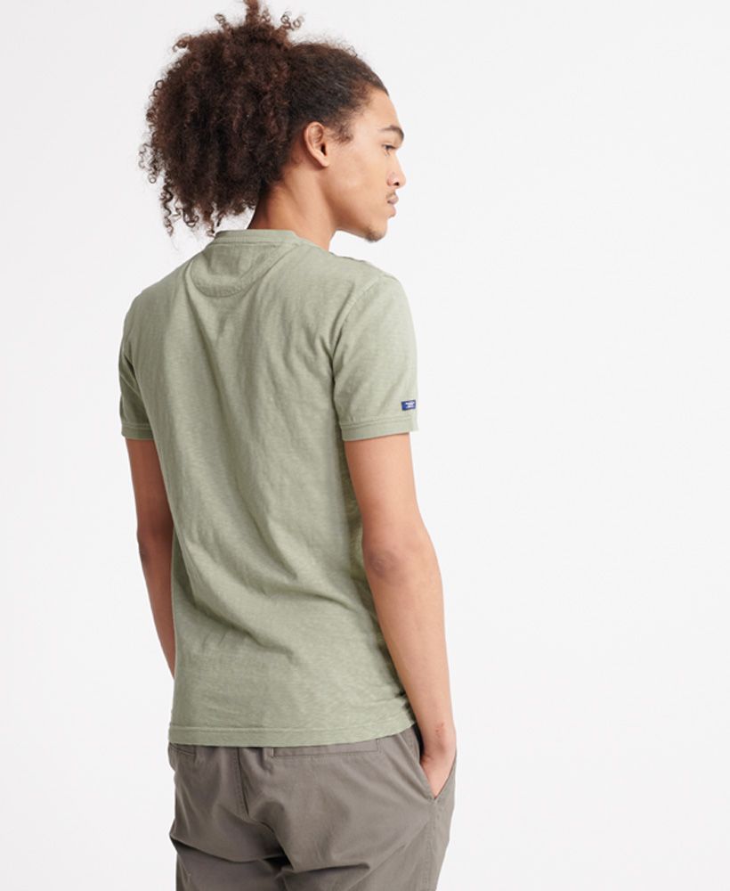Superdry women's Heritage short sleeved henley T-shirt. This short sleeved tee features a button up design, a henley style collar and ribbed collar and cuffs. Finished with a Superdry logo tab to one side seam.