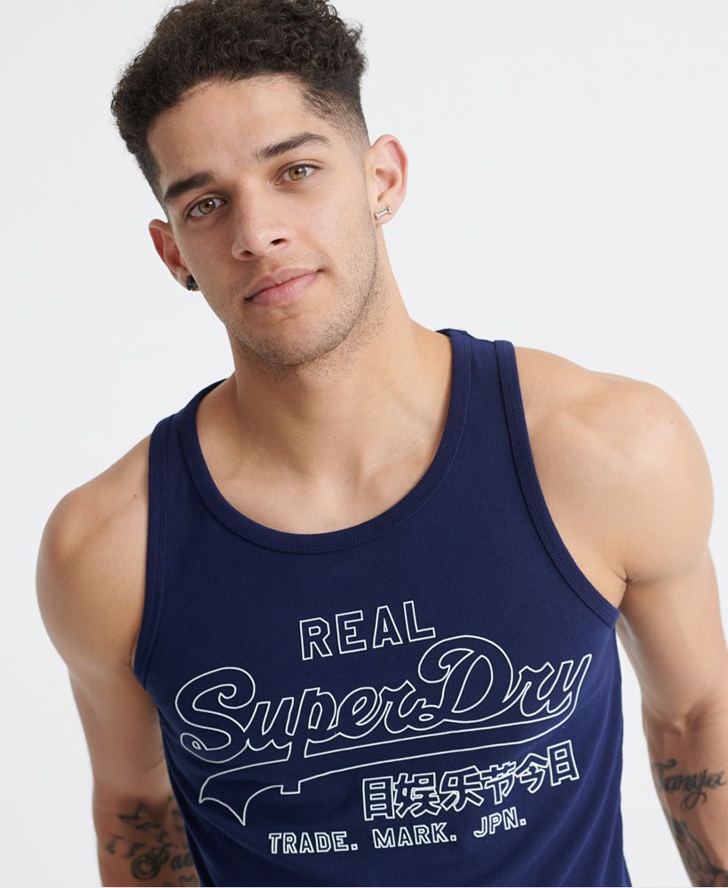 Superdry men's Vintage Logo outline pop vest top. This sleeveless vest top features a relaxed crew neckline, and ribbed trims. Finished with a textured Superdry outline graphic across the chest.