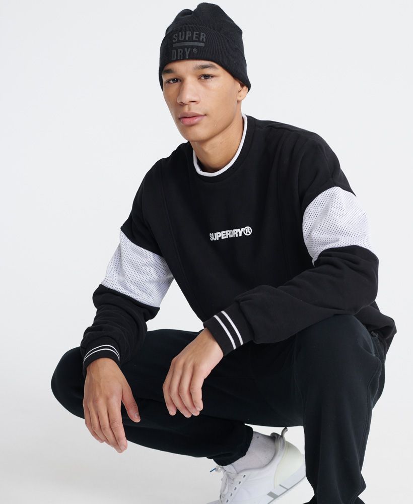 Superdry men's Future Mascot Airtex loopback crew sweatshirt. A sweatshirt featuring crew neckline, long sleeves, mesh panels on both sleeves, and ribbed cuffs and hem. Finished with a Superdry logo print on the chest, and a Superdry logo patch above the hem.Oversized fit