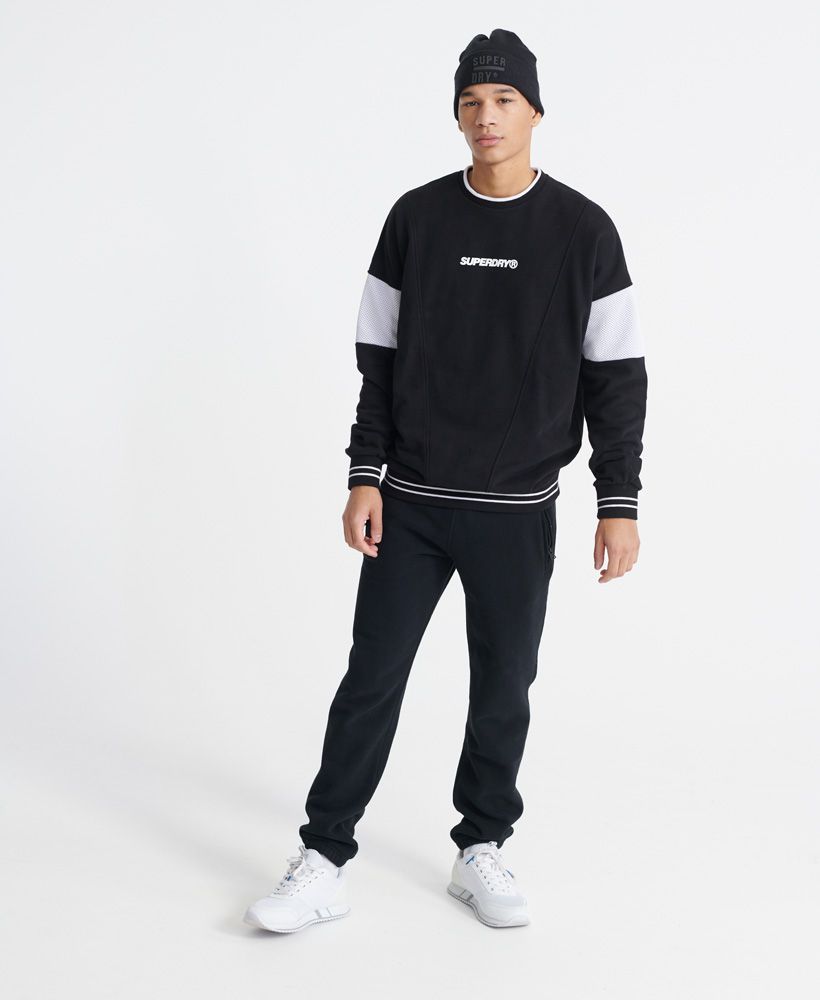 Superdry men's Future Mascot Airtex loopback crew sweatshirt. A sweatshirt featuring crew neckline, long sleeves, mesh panels on both sleeves, and ribbed cuffs and hem. Finished with a Superdry logo print on the chest, and a Superdry logo patch above the hem.Oversized fit