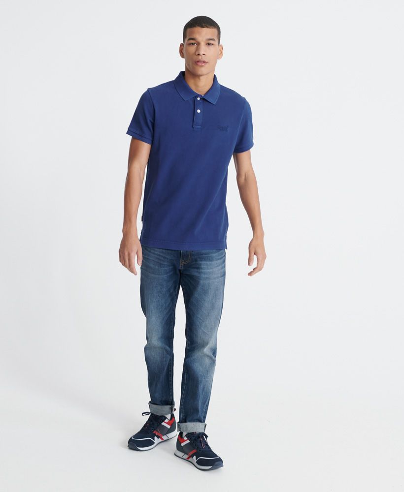 Superdry men's Organic Cotton Vintage destroyed Pique Polo shirt. A classic polo shirt featuring a button fastened collar, and side seam splits with reinforced stitching. Finished with an embroidered Superdry logo on the chest, and a Superdry logo tab on the side seam.Made with Organic Cotton - Made using cotton grown using organic farming methods which minimise water usage and eliminate pesticides, maximising soil health and farmer livelihoods.Slim fit