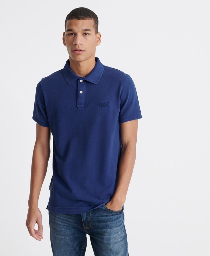 Superdry men's Organic Cotton Vintage destroyed Pique Polo shirt. A classic polo shirt featuring a button fastened collar, and side seam splits with reinforced stitching. Finished with an embroidered Superdry logo on the chest, and a Superdry logo tab on the side seam.Made with Organic Cotton - Made using cotton grown using organic farming methods which minimise water usage and eliminate pesticides, maximising soil health and farmer livelihoods.Slim fit
