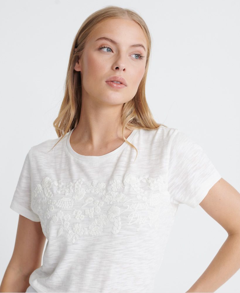 Superdry women's Tinsley embroidery T-shirt. A lightweight tee featuring a crew neck, short sleeves and an embroidered Superdry logo and floral design across the chest. Finished with a Superdry logo tab on the hem.