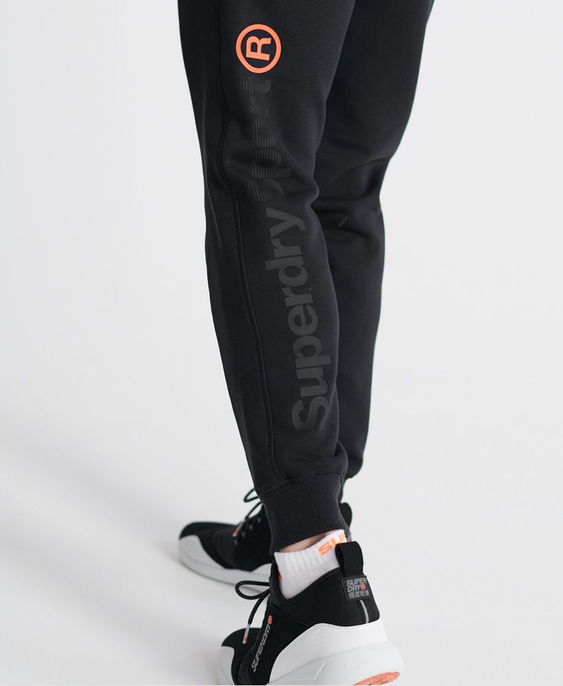 Superdry men's Core sport joggers. These comfortable joggers feature an elasticated drawstring waist, two zip fastened pockets, and ribbed cuffs. Finished with a small Superdry Sport logo print on the front, a Superdry print down the back of one leg, and Japanese characters on the back of the waist.Relaxed: A classic fit. Not too slim, not too tight – no distractions here