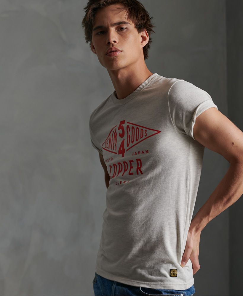 Superdry men's Copper Label T-shirt. Our classic Copper Label t-shirts return this season with this short sleeved tee featuring a crew neckline and a large crackle effect Copper Label print across the front. Finished with a Superdry Copper Label logo patch above the hem.Slim fit