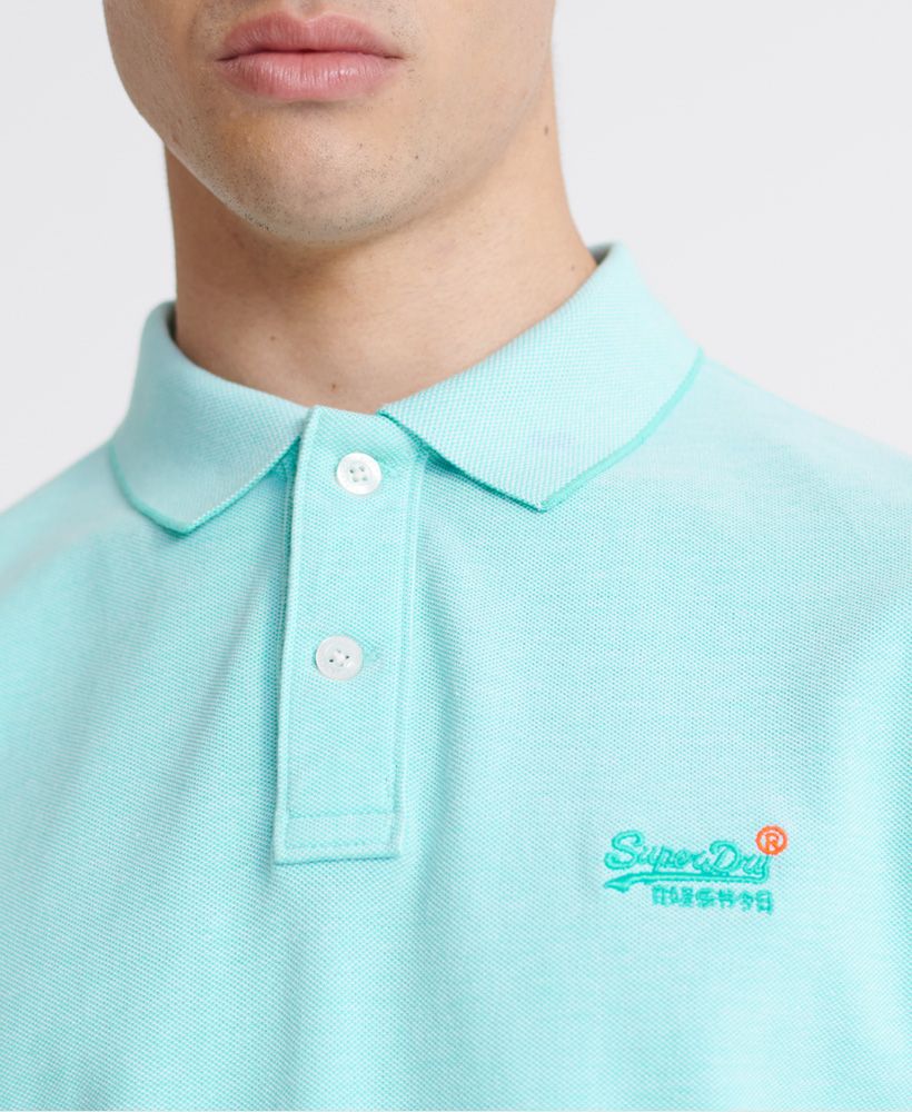 Superdry men's Classic pique short sleeve polo shirt. This classic style polo shirt features a half button fastening, short sleeves and reinforced side splits. Completed with a Superdry logo tab on the side seam and an embroidered Superdry logo on the chest.Made with Organic Cotton - Grown using only organic inputs and no artificial chemicals, which leads to improved soil condition, stronger biodiversity and better health among the cotton growers and uses between 60-90% less water to grow. By 2030, all Superdry Cotton will be Organic.Slim fitMade with Organic Cotton - Made using cotton grown using organic farming methods which minimise water usage and eliminate pesticides, maximising soil health and farmer livelihoods.