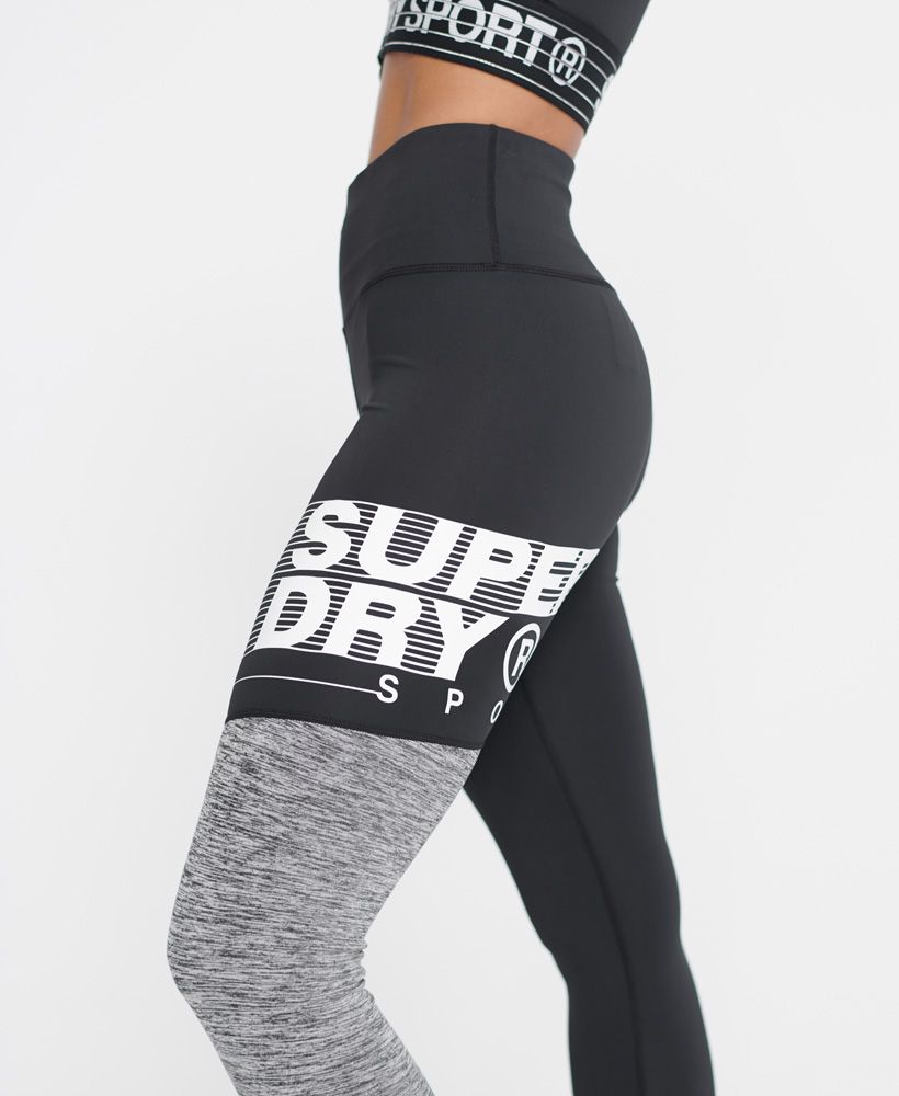 Superdry women's Training graphic 7/8 leggings. Made with Superdry fabric that helps you stay dry and cool, enabling you to train at your best for longer. These stretchy leggings feature an elasticated waistband, a colour block design on one leg, and a colour block stripe design down the other leg. Finished with a textured Superdry logo on the thigh.