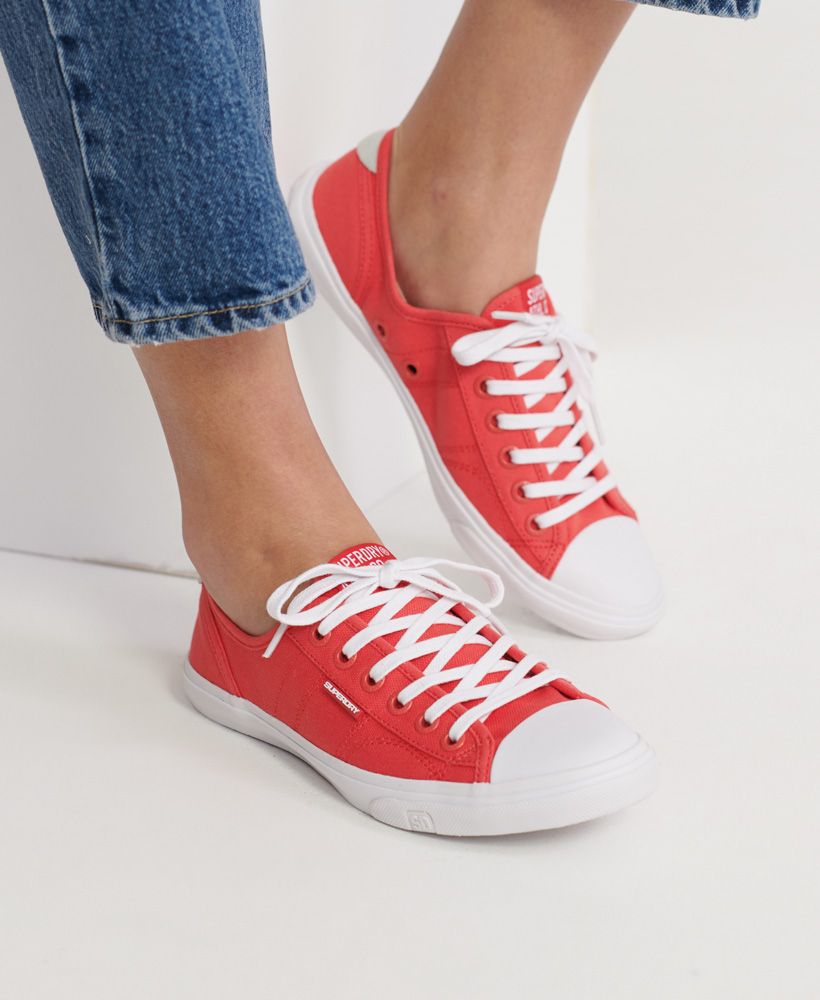 Superdry women's Low Pro classic sneakers.The perfect everyday trainers. Made with a light canvas material they feature a lace-up fastening, a Superdry logo patch on the tongue, a rubber logo tab on the side and a small leather patch on the heel. Completed with a Superdry logo on the outer sole.