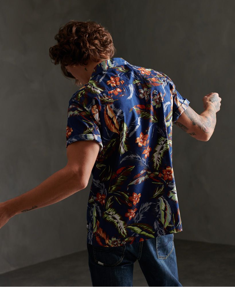 Superdry men's Hawaiian box short sleeve shirt. A lightweight shirt featuring an all over print design, a main button down fastening, short sleeves and small sides seam splits. Finished with a Superdry logo patch above the hem.