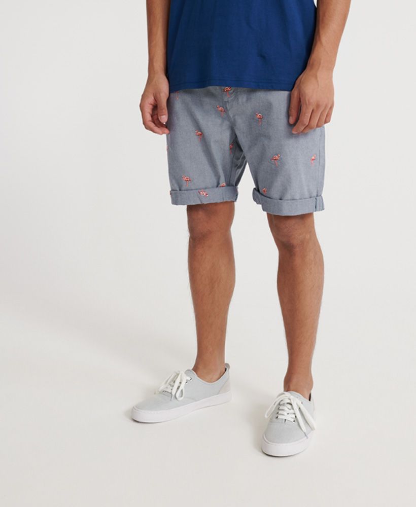 Chino shorts are a must have summer essential and we've got just the pair to help you liven up your collection. Introducing our international all over embroidered chino short.Zip and button fasteningBelt loopsFour pocket designRoll up cuffsAll over embroidered pattern