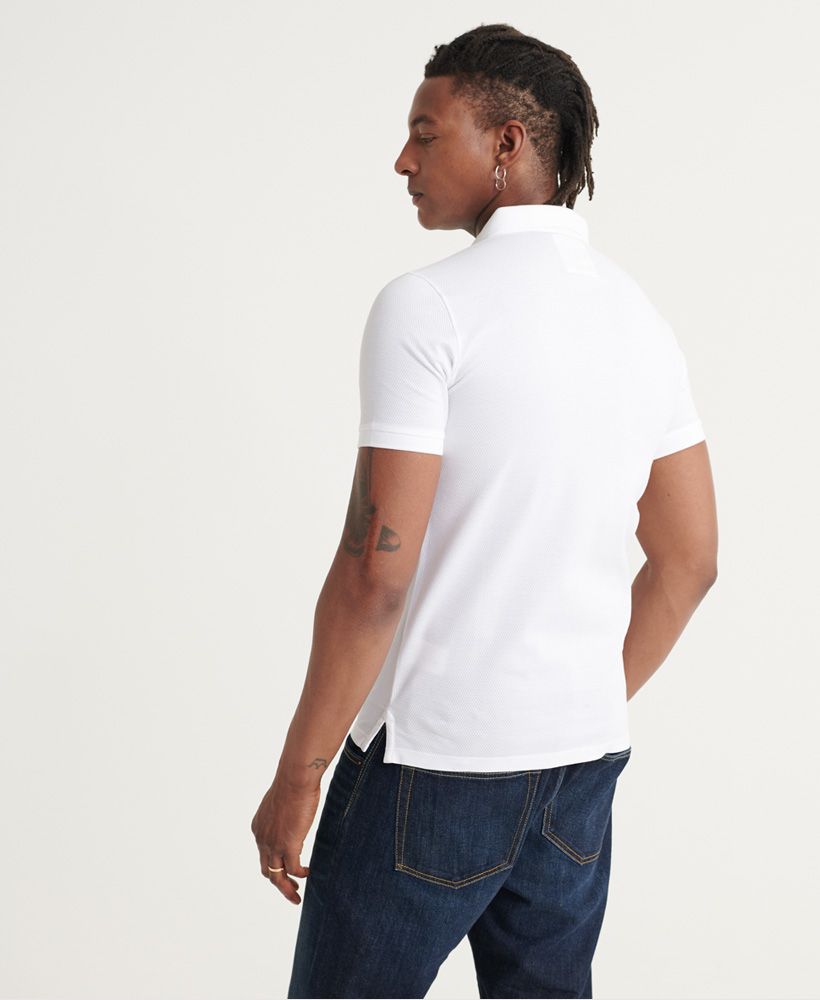 Superdry men's Edit short sleeve polo shirt. A classic shirt with a ribbed collar, button fastenings and side splits to the hem. Finished with ribbed cuffs and a Superdry logo tab on one side seam.Slim fit