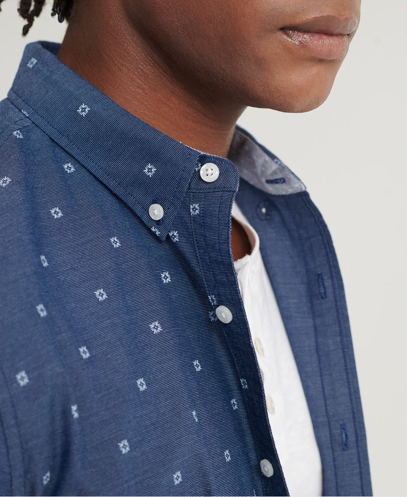 Superdry men's Classic Shoreditch Print short sleeved shirt. An eye-catching addition to your smart-casual wardrobe, this shirt features an all over print design, short sleeves and a button down fastening. Finished with a Superdry logo patch on the placket.