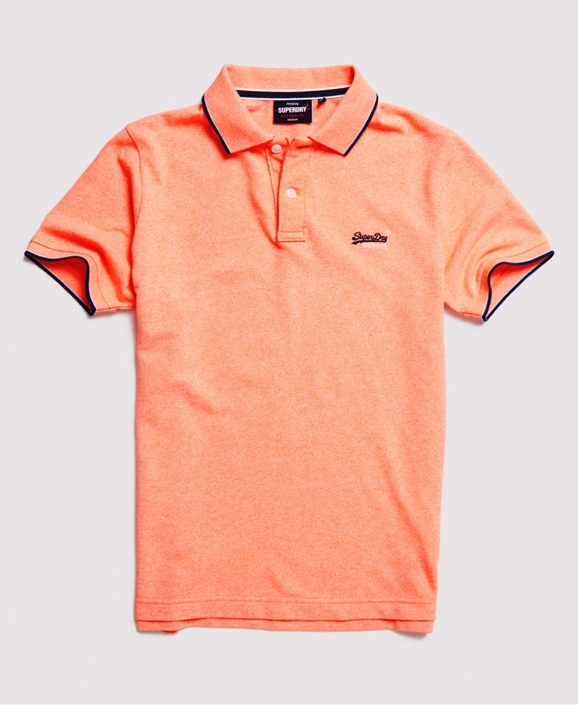 Superdry men's Poolside pique polo shirt. Relax your style this season with a classic polo shirt featuring short sleeves, a button up collar, side split on the seams, and a longer hem at the back. Pair with jeans for a casual look, or chinos for a smarter look.Contains Over 60% Organic Cotton - which is grown without the use of artificial chemicals, leading to better soil, 60-90% less water used, and better health for farmers.Slim fit