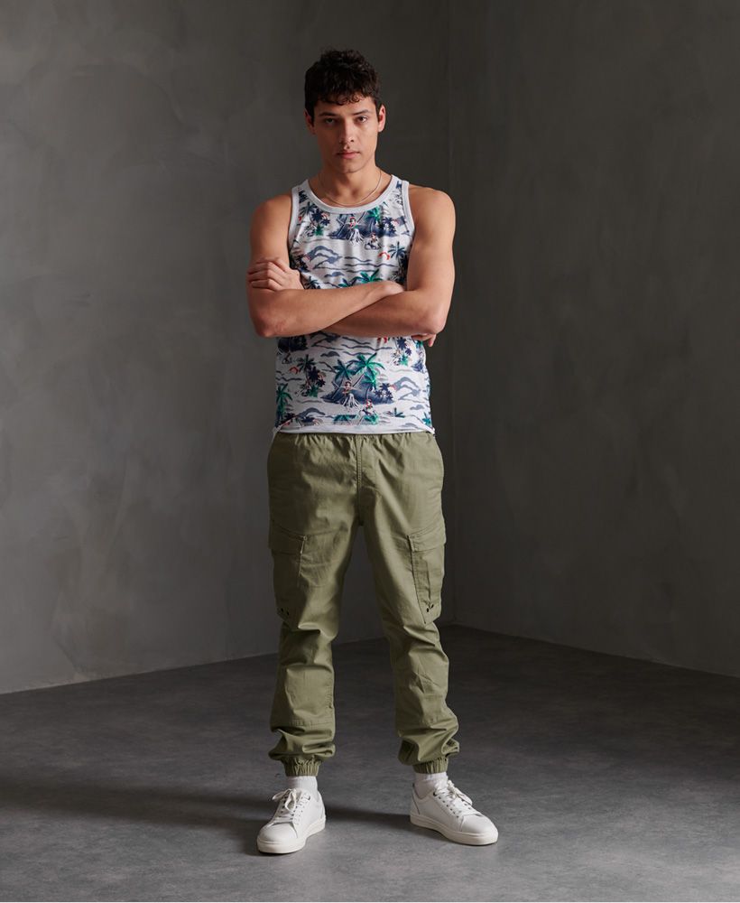 Superdry men's All Over Print supply vest top. Update your vest collection this season with this vest top featuring a ribbed trim on the neck and straps, an all over print design and an embroidered Superdry logo on the chest.