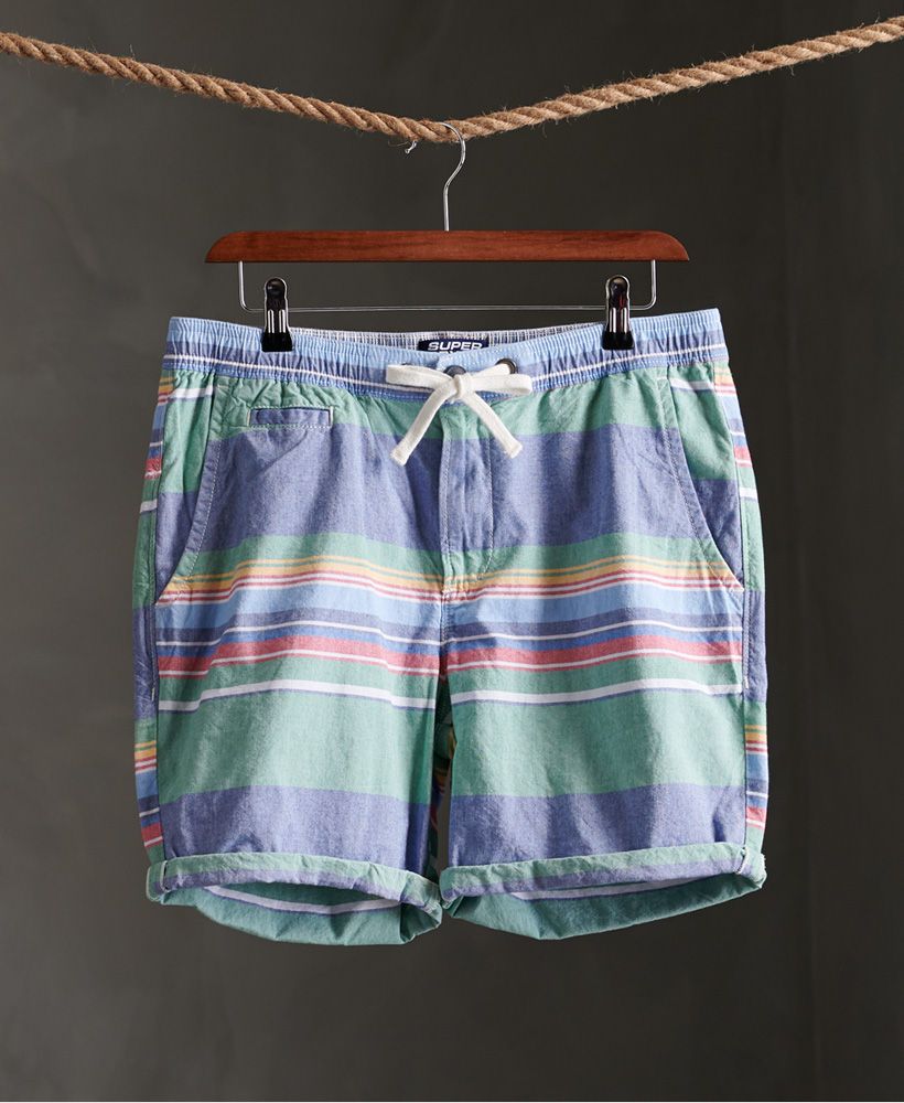 Superdry men's Sunscorched shorts. Perfect for the warmer weather, these shorts feature a zip and button main fastening, an elasticated drawstring waist and a five pocket design. Finished with a Superdry logo badge on the back.