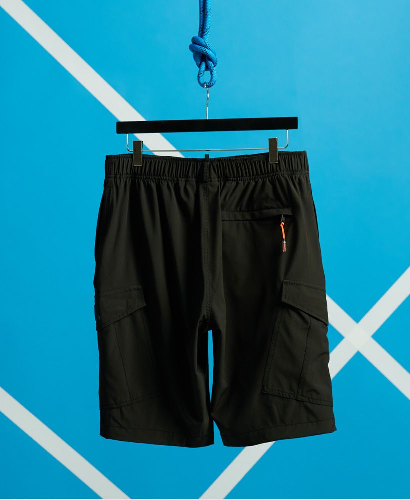 Superdry men's Worldwide Cargo boardshorts. These shorts feature a drawstring detailing with an elasticated waistband, two side hook and loop pockets, a back zip pocket with a loop for your locker key and a loop on the back essential for drying. Complete with a Superdry logo badge on one pocket.