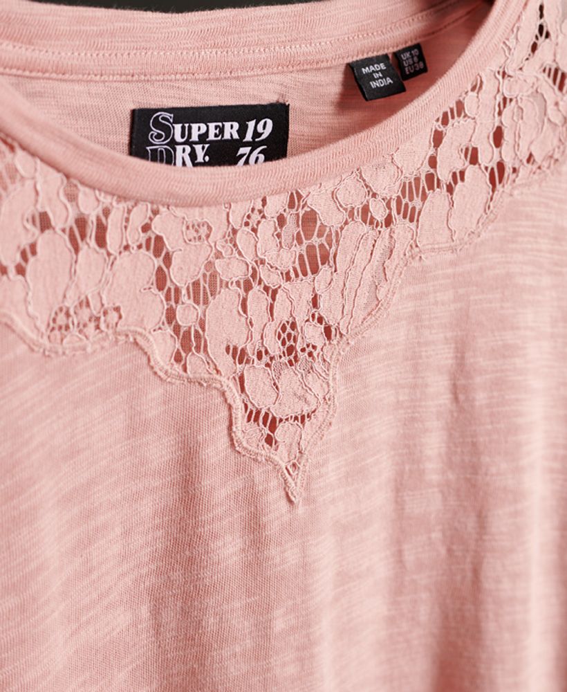 Superdry women's Ellis lace long sleeve top. This top features long sleeves, a crew neck with lace detailing and a lace trim on the hemline. Finished with a metal Superdry logo on the hem. The Ellis lace long sleeve top is perfect for pairing with jeans and boots to complete the look this season.