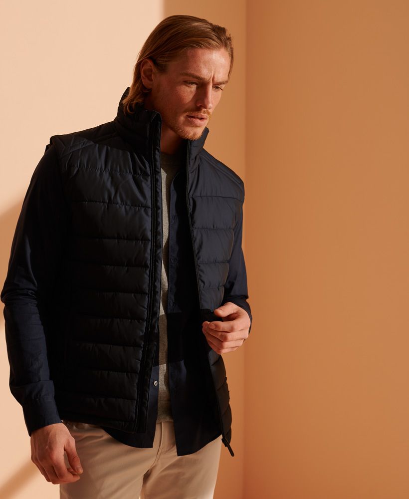 Designed with your warmth in mind, the Fuji gilet features 100% recycled polyester padding, perfect for layering up over a classic hoodie this season.Main zip fasteningThree pocket designPolyester paddingBungee cord adjustable hemSignature logo patchThe padding in this jacket is 100% Recycled Polyester – each jacket contains up to 10 recycled bottles, this avoids these bottles being sent to landfill or polluting our oceans.