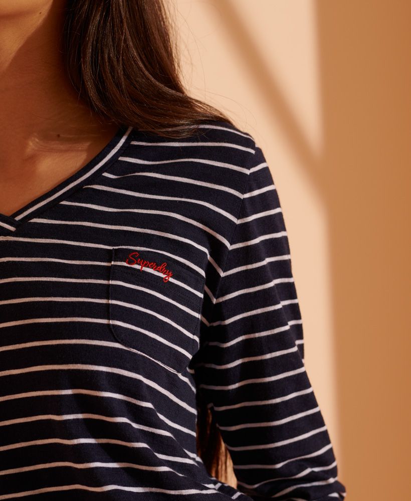 A classic long sleeved top with a v-neck and stylish stripes to elevate your wardrobe. Made with over 50% Organic Cotton.V-NeckLong sleevesChest pocketStriped designEmbroidered logoSignature logo tabMade using a blend of Organic Cotton and TENCEL™.Organic Cotton is grown without the use of artificial chemicals, leading to healthier soil, less water used, and better health among farmers.Tencel™ Modal fibres are produced by an Eco Soft technology - an environmentally responsible choice.