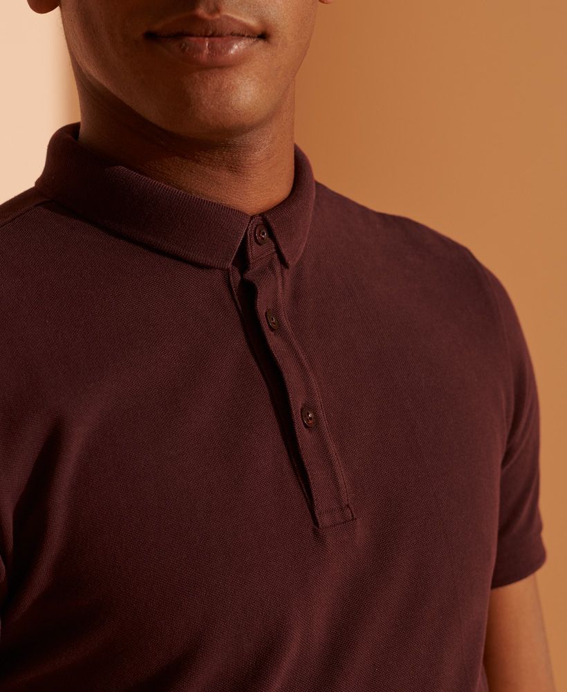 look no further for your Classic Polo Shirt needs. This simplistic polo is made from our premium soft feel organic cotton allowing you to feel great.Organic cottonStandard collarThree button placketRibbed cuffsSplit side seamsSignature logo tabMade with Organic Cotton - Grown using only organic inputs and no artificial chemicals, which leads to improved soil condition, stronger biodiversity and better health among the cotton growers and uses between 60-90% less water to grow. By 2030, all Superdry Cotton will be Organic.