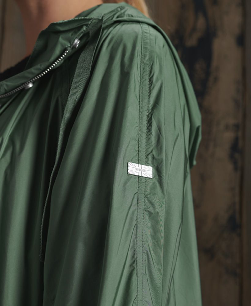 Superdry women's Essentials nylon rookie parka coat. This lightweight coat features a drawstring adjustable hood, a zip and popper fastening, drawstring adjustable waist, two pockets, and elasticated hem and cuffs. Finished with a Superdry logo badge on one sleeve.