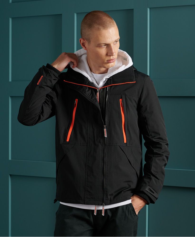 Superdry men's Hooded tech SD-Windattacker jacket. A classic member of our SD-Wind family, this water resistant jacket features a mesh lining, multi zip fastenings, bungee cord adjustable hood, two zip fastened pockets, two popper fastened pockets, an inner pocket, bungee cord adjustable hem, and hook and loop adjustable cuffs. Finished with an embroidered Superdry logo on the back, printed branding on one sleeve, and a rubber Superdry logo tab on one arm.