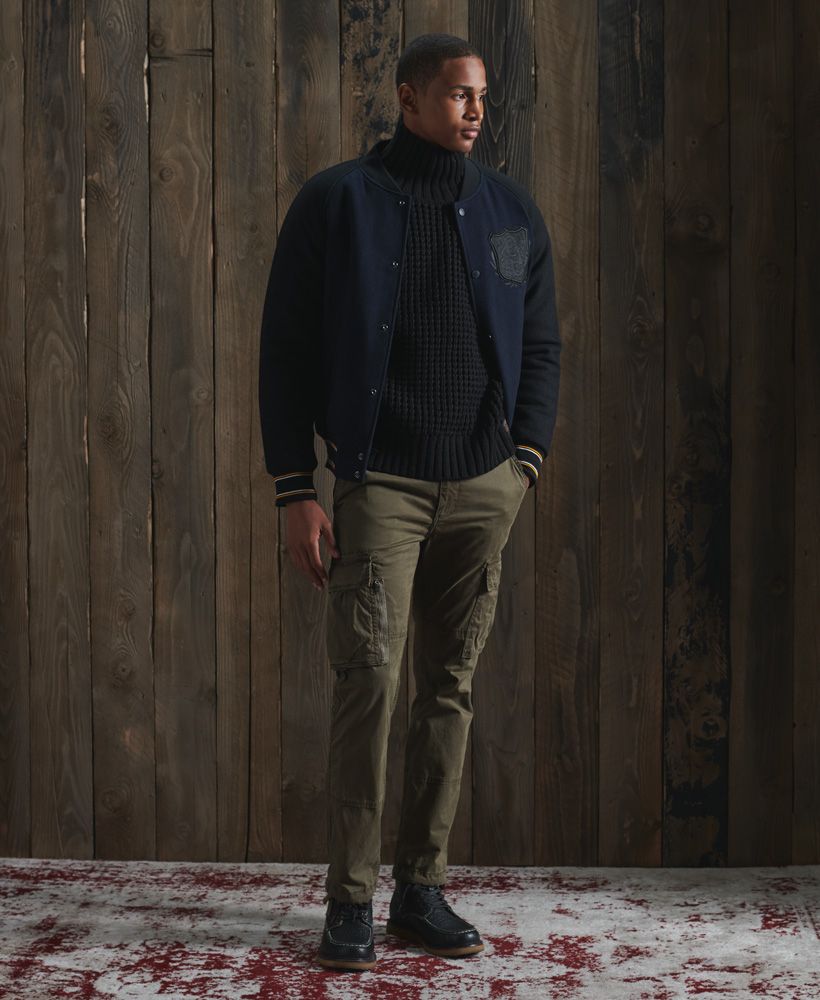 Perfect for keeping warm this season, this jumper features a high roll neck and thick knit design essential for keeping the cold out.Roll neck designRibbed collar, cuffs and hemKnit designSignature logo patch