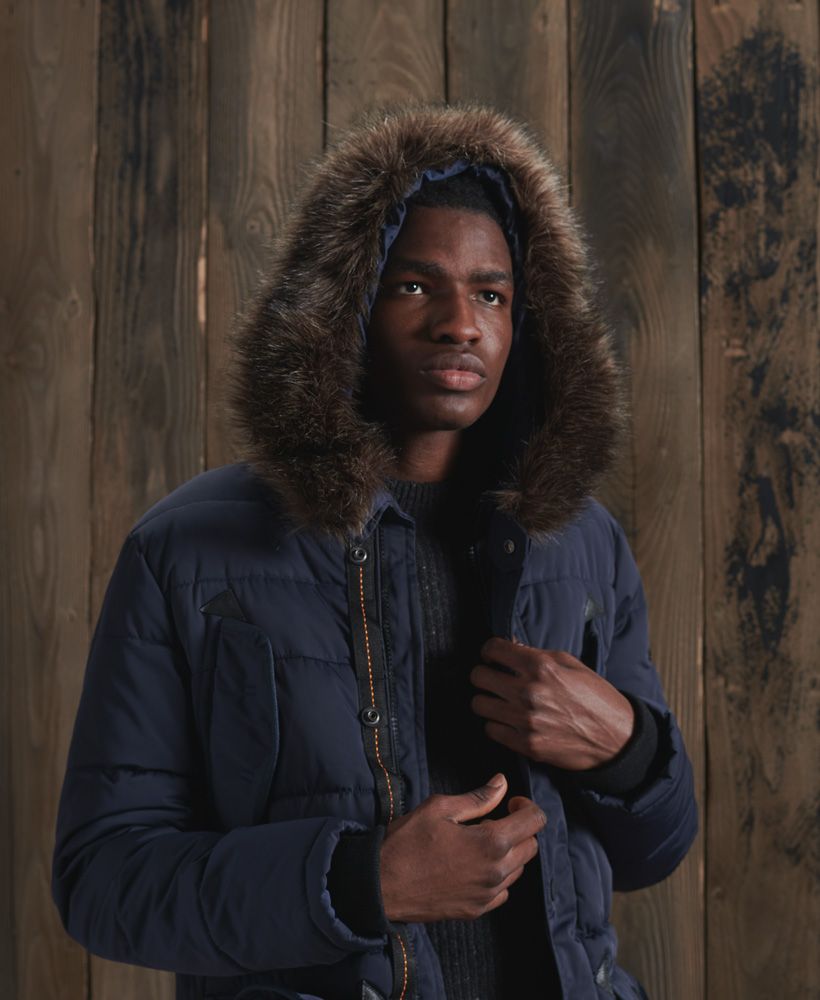Stay warm this season and look great doing it. The Chinook Parka coat is just what you need, featuring a removable faux fur trim, elasticated cuffs and an all over padded design with a recycled polyester filling.Main zip and popper fasteningRemovable faux fur trimSix pocket designRibbed cuffsSide seam zipsSignature logo patchThe padding in this jacket is 100% Recycled Polyester – each jacket contains up to 10 recycled bottles, this avoids these bottles being sent to landfill or polluting our oceans.