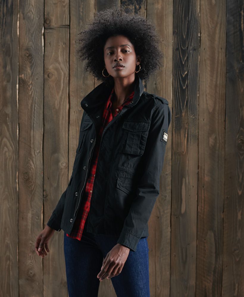 Superdry women's Ripstop Rookie jacket. This military inspired jacket features a main zip and popper fastening, a drawstring waist, four popper fastened pockets and two pouch pockets. This jacket also features popper fastened cuffs, zip detailing on the collar and shoulder epaulettes. Finished with a Superdry logo badge on one sleeve.