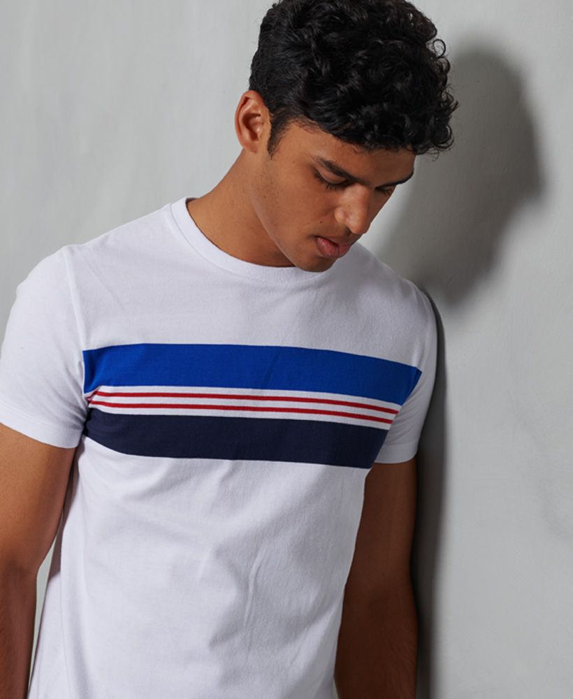 Add a pop of colour to your basics this season with the R&P chestband tee featuring a colour block stripe design. This t-shirt will look great paired with jeans to complete the look.Slim fit – designed to fit closer to the body for a more tailored lookClassic ribbed crew necklineShort sleevesStripe designSignature logo patchMade with Organic Cotton - Grown using only organic inputs and no artificial chemicals, which leads to improved soil condition, stronger biodiversity and better health among the cotton growers and uses between 60-90% less water to grow. By 2030, all Superdry Cotton will be Organic.