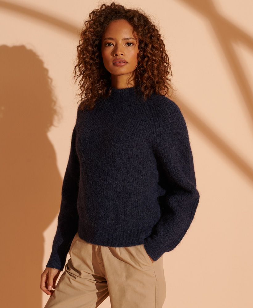 Effortless luxury, the Alpaca Blend Crew Knit Jumper is perfect for creating a minimalist outfit this season. Pair with your favourite jeans and boots and layer up with a leather jacket for extra warmth and to complete this stylish look.High crew necklineLong sleevesRibbed collar, cuffs and hemSignature logo tabA blend containing Alpaca.Alpacas have a low impact on the environment, whilst producing fibres which are incredibly soft and warm. 