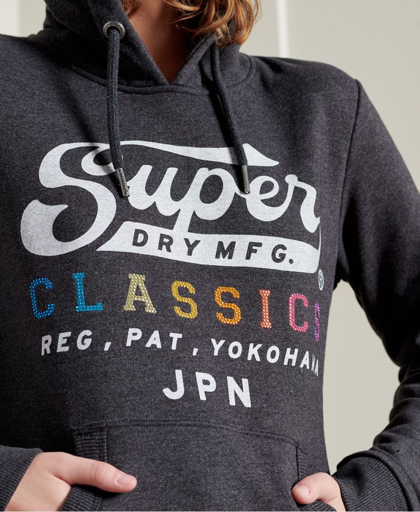 Looking for a relaxed vintage feel? Look no further with Rainbow Pop Classic Hoodie, designed to be a blast from the past.Relaxed fit – the classic Superdry fit. Not too slim, not too loose, just right. Go for your normal sizeDrawstring hoodRibbed cuffs and hemFront pouch pocketSoft brushed liningPrinted graphic with rhinestonesSignature logo tab