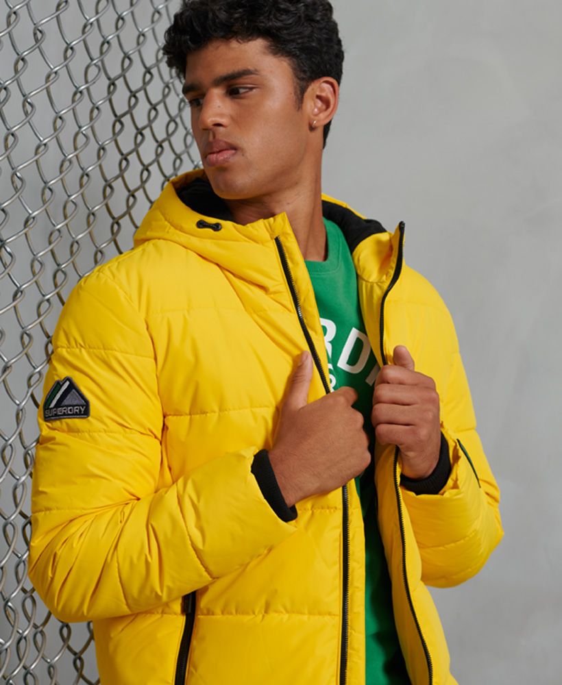 Looking for a new jacket this season? Look no further than the Sports puffer jacket to keep you warm and looking great. Featuring a bungee cord adjustable hood and padding made from recycled Polyester.Main zip fasteningRecycled PolyesterBungee cord adjustable hoodThree pocket design, including one inner pocketFleece lined hood and bodyBungee cord adjustable hemElasticated cuffsSignature logo patchThe padding in this jacket is 100% Recycled Polyester – each jacket contains up to 10 recycled bottles, this avoids these bottles being sent to landfill or polluting our oceans.