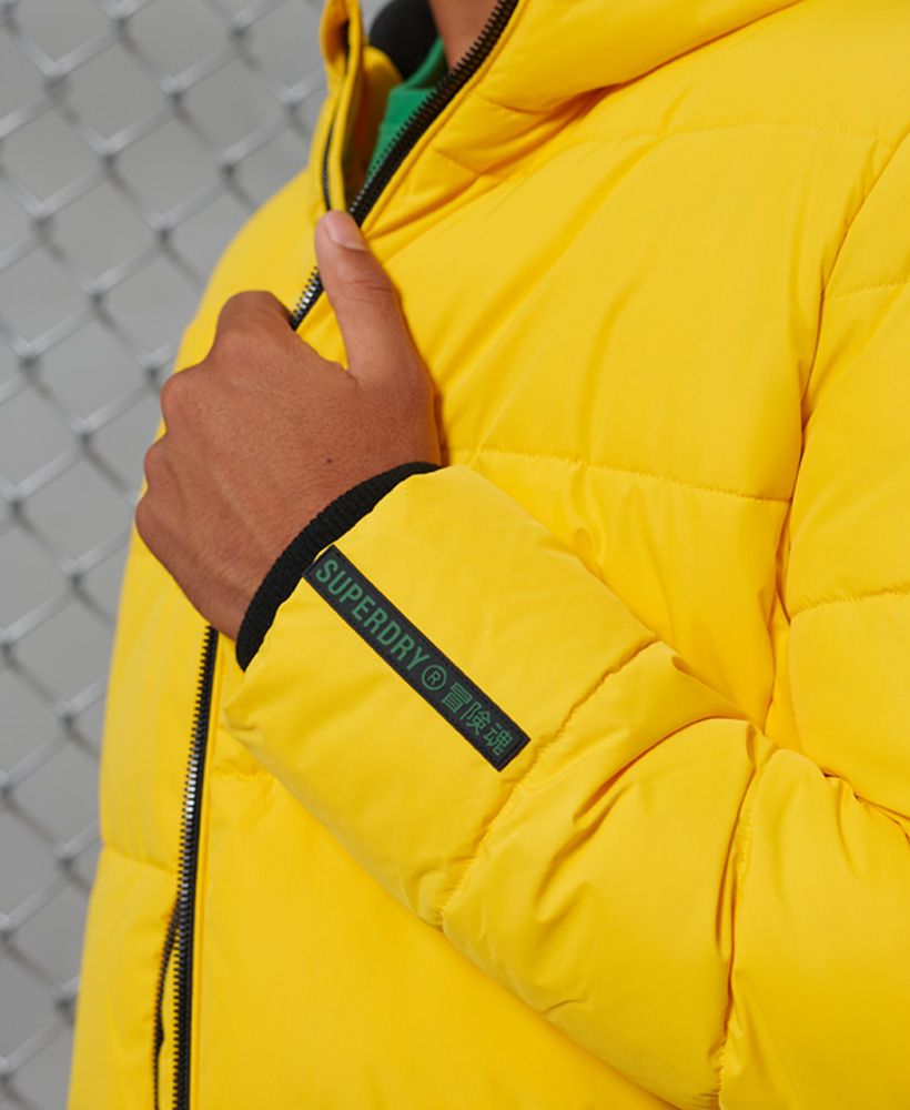 Looking for a new jacket this season? Look no further than the Sports puffer jacket to keep you warm and looking great. Featuring a bungee cord adjustable hood and padding made from recycled Polyester.Main zip fasteningRecycled PolyesterBungee cord adjustable hoodThree pocket design, including one inner pocketFleece lined hood and bodyBungee cord adjustable hemElasticated cuffsSignature logo patchThe padding in this jacket is 100% Recycled Polyester – each jacket contains up to 10 recycled bottles, this avoids these bottles being sent to landfill or polluting our oceans.