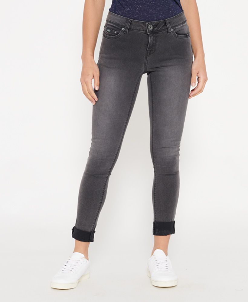 Superdry women's Cassie Skinny Jeans. A pair of mid-rise skinny fit jeans featuring the classic five pocket design, a button fly fastening and belt loops. The Cassie Skinny jeans are finished with a Superdry Denim patch on the coin pocket and an embossed logo patch on the back waistline.Skinny Fit. Fitting where they touch, as that’s what they’re designed to do. With a hint of stretch just to make sure, they’re cut to cling close, right from your seat through the thigh and down to a narrow ankle – the ultimate rock star look.