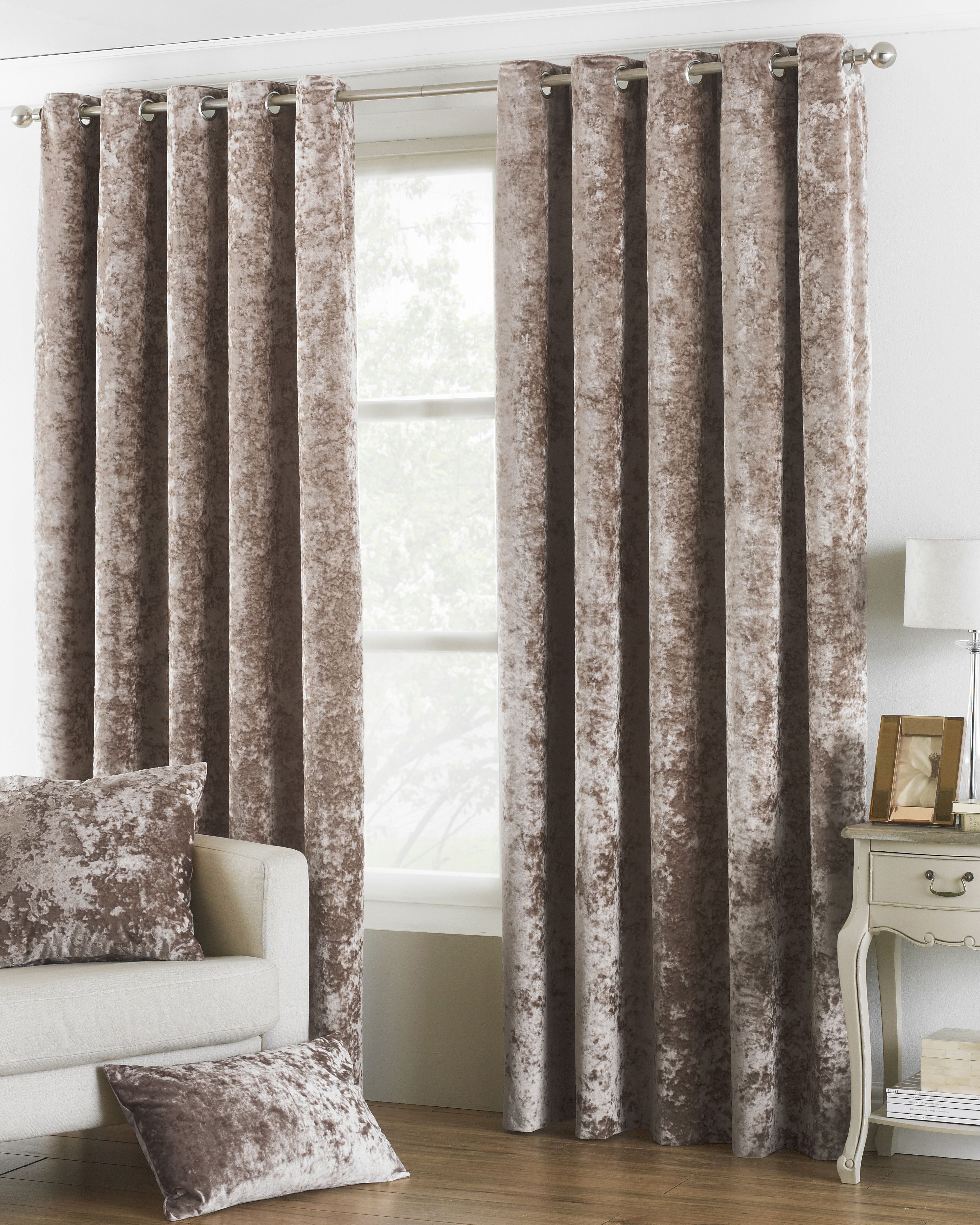 The Verona crushed velvet ringtop eyelet curtains provide you with a opulent centrepiece for your home. The velvet-look material and insulating properties will keep you feeling cosy in the colder months while it's room dakrening design will shield you from the low winter sun. Large ringtop detailing make it easy to install, meaning no fussy hooks . The Verona eyelet curtains are available in a range of sizes and colours to suit even the quirkiest of homes. Coordinate with other Verona products to harmonize your bed with your curtains. Velvet has been picked as the statement fabric of choice for home interiors in 2018. Plush and regal the construction of the fabric allows it to catch and reflect light giving it a shimmering appearance. Velvet products have intensely rich colours and suit funkier, nontraditional spaces. Velvet is thick giving it room darkening properties along with an insulation barrier.