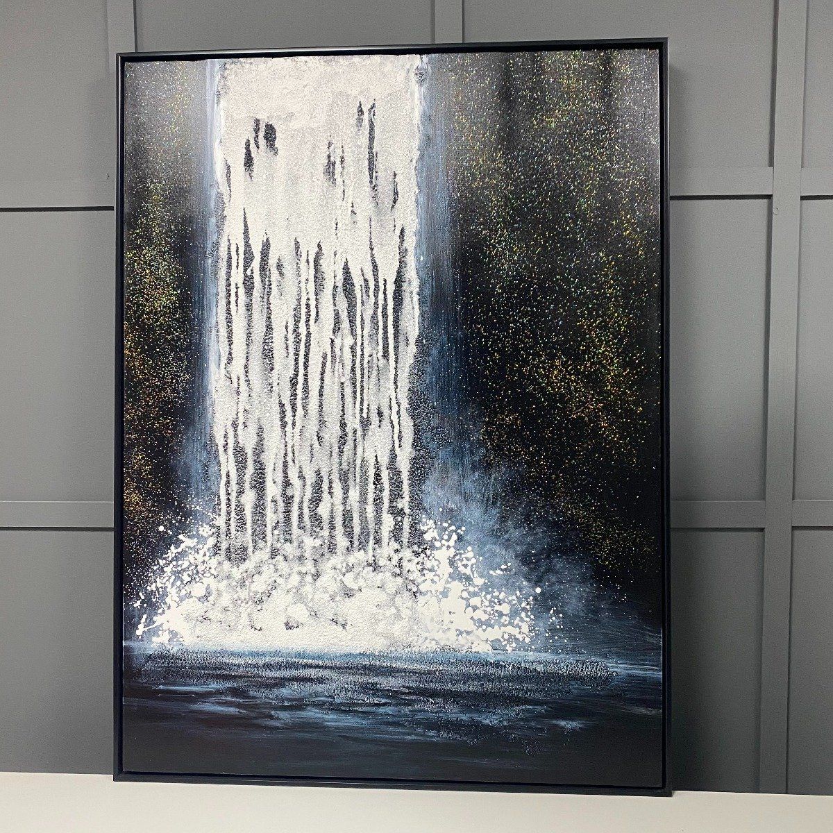 Abstract waterfall painted canvas boasting a black frame.

Update any room with the Abstract Waterfall painted canvas boasting glitter detailing and black frame. Featuring a textured waterfall scene, perfect for contemporary interiors.  