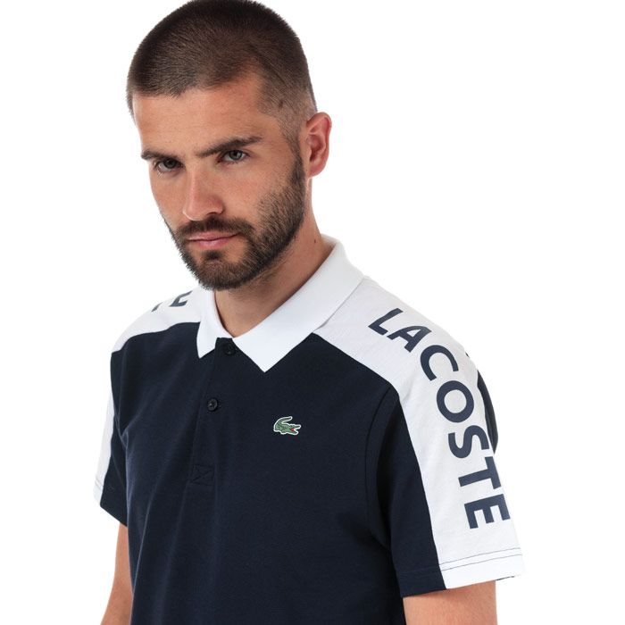 Mens Lacoste Sport Breathable Resistant Pique Polo  Navy - White.<BR><BR>- Run-resistant and ultra-dry breathable piqué.<BR>- Two-button ribbed polo collar.<BR>- Contrast short sleeves<BR>- Lacoste branding on right shoulder<BR>- Green crocodile transfer on chest<BR>- 100% Polyester  Machine washable.<BR>- Ref: YH300100R20