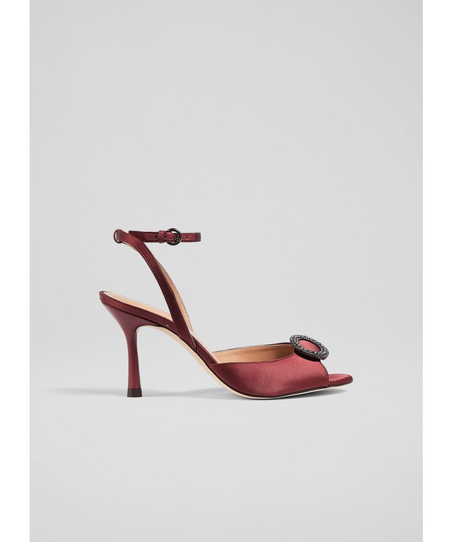 An elegant and timeless take on a party sandal, our Belle sandals have a glamorous, vintage feel. Crafted from lustrous burgundy satin, they're a peeptoe style with a sparkling, oval-shaped crystal buckle embellishment, a delicate ankle strap and a shapely stiletto heel. Wear them with your favourite party dresses or to instantly dress up a pair of tailored trousers.