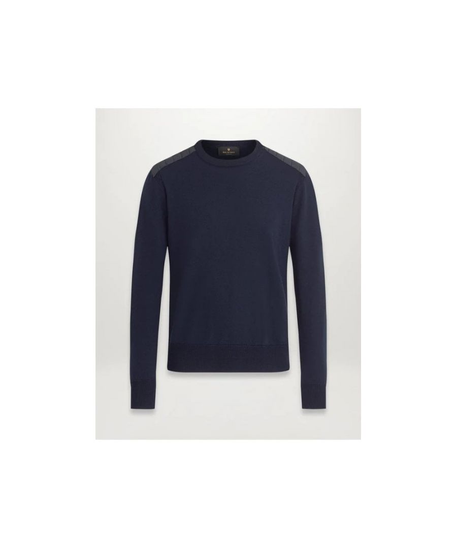The sweater is your first line of defence against the cold. Our men's Kerrigan Crew Neck is crafted from washed navy virgin Merino wool, with ribbed side panels and moto-inspired quilted shoulders to let you layer with individual style.\nVirgin merino wool with polyester detailingLong sleeve sweater with crew neckRibbed collar, cuff and hemRib panelling at the sidesChannel quilted shoulders reinforcement detailingSignature embroidered phoenix patch on the left sleeve\n 