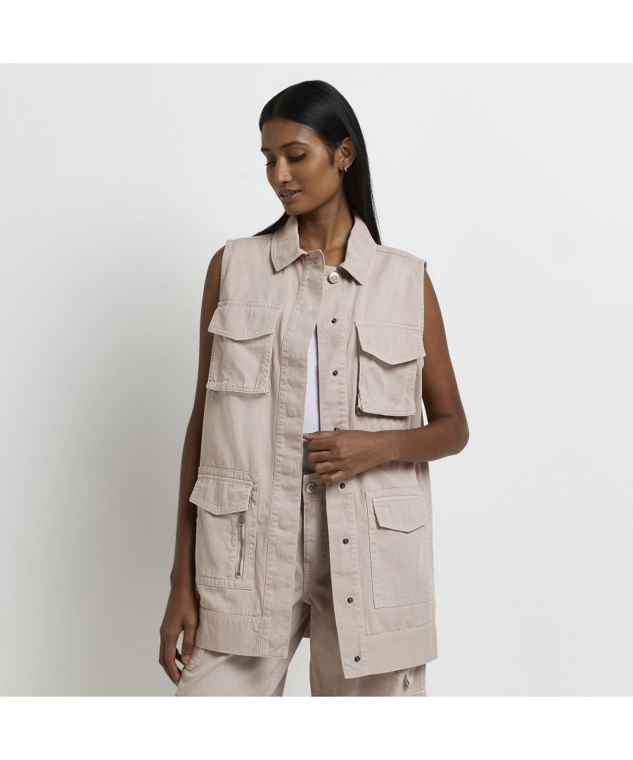 > Brand: River Island> Department: Women> Colour: Brown> Type: Jacket> Style: Gilet> Material Composition: 100% Cotton> Outer Shell Material: Cotton> Neckline: Collared> Sleeve Length: Sleeveless> Pattern: No Pattern> Occasion: Casual> Jacket/Coat Length: Long> Size Type: Regular> Closure: Button> Season: SS22