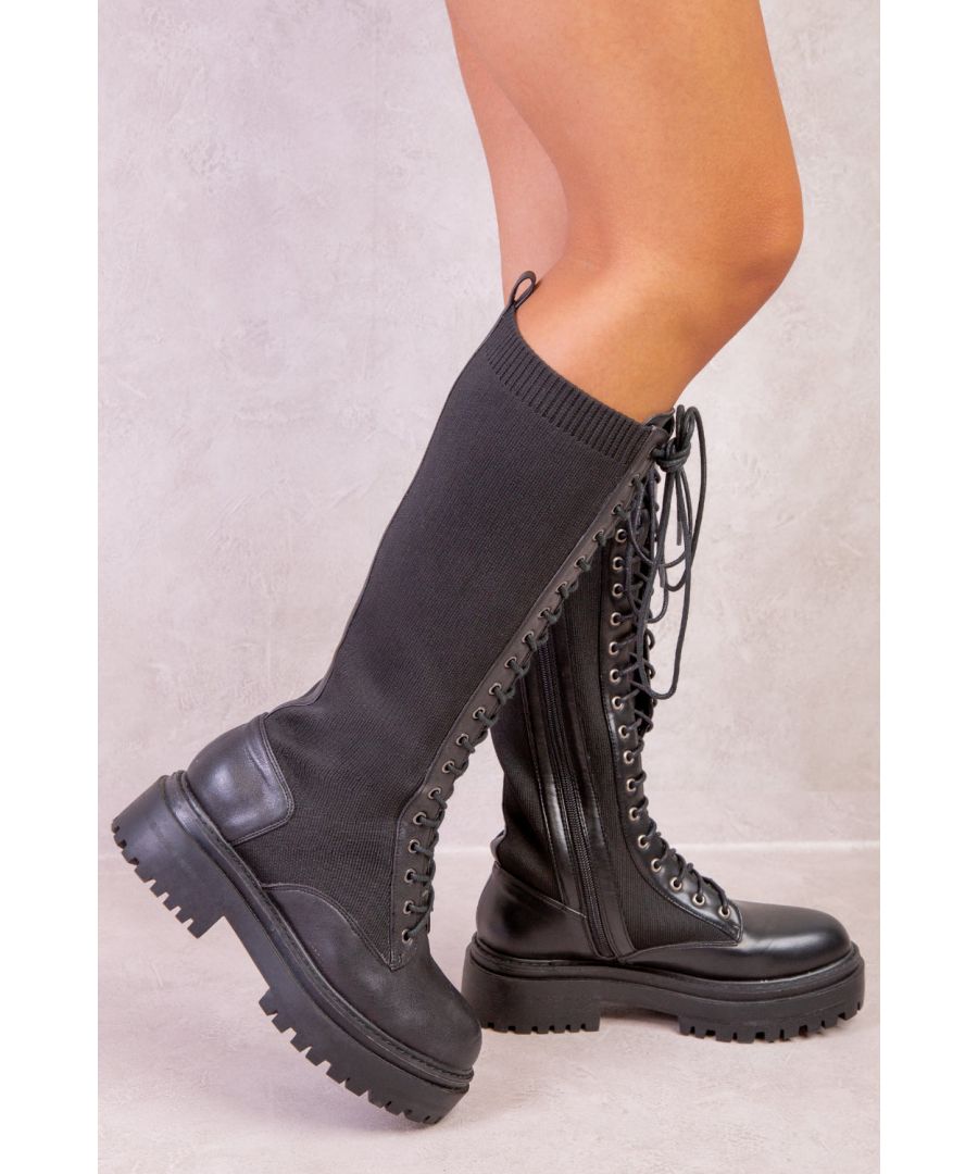 Women’s knee high calf lace up boots featuring knitted panels down the legs, back ankle tab, lace up front, full inside zip closure and chunky toothed sole.