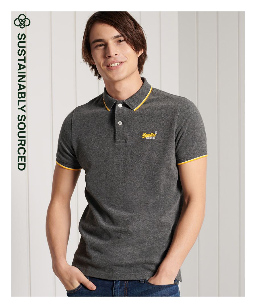 Superdry men's Poolside pique polo shirt. Relax your style this season with a classic polo shirt featuring short sleeves, a button up collar, side split on the seams, and a longer hem at the back. Pair with jeans for a casual look, or chinos for a smarter look.Slim fit – designed to fit closer to the body for a more tailored look