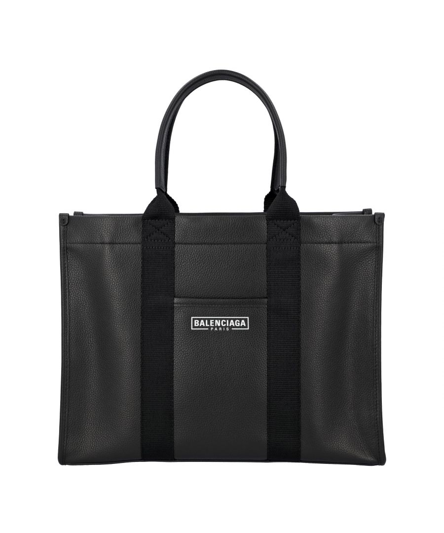 Balenciaga's tote bag crafted in black grained leather. It features silver-tone hardware, double handle and adjustable / removable strap. Black canvas-lined interior with flat and zip pockets. The design is completed by protective metal feet and front flat pocket embellished by contrasting logo print. Made in italy\nBalenciaga Balenciaga Hardware medium grainy leather tote bag\nColor: black\nMaterial: Leather\nCondition: new with tag\nSize: One Size\nSign of wear: No\nSKU: 102940 / 6714002103A1000 / 6714002103A1000_OS \nDimensions:  Length: 125 mm, Width: 340 mm, Height: 270 mm