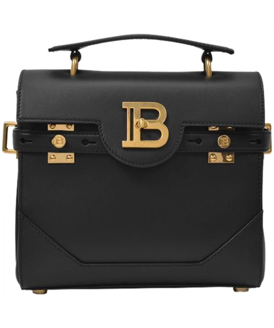 The runway-inspired Bbuzz collection pays tribute to maison Balmain's craftsmanship. We love this black leather piece for its minimalist design, with straps and gold-tone hardware, with the new Balmain logo. A new must-have to wear every day, with a blazer and a pair of pumps. Top handle height : 3 cm - Shoulder strap length : 45 cm. Worn two ways - one adjustable detachable shoulder strap. Material : grained calfskin. Lining : cotton. Colour : Noir - 0Pa Noir 0Pa. Closure : magnetic flap closure. Interior: one zipped pocket, one flat pocket.