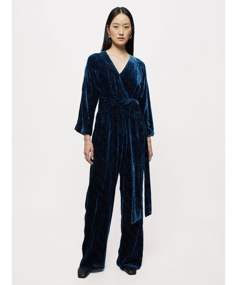 Stylish velvet devore jumpsuit in a semi transparent zebra pattern. Featuring a v-neck line, kimono bracelet length sleeves and a fixed waist seam with pleats. Designed with a palazzo wide leg and versatile wrap around sash belt. Ideal for occasion dressing.