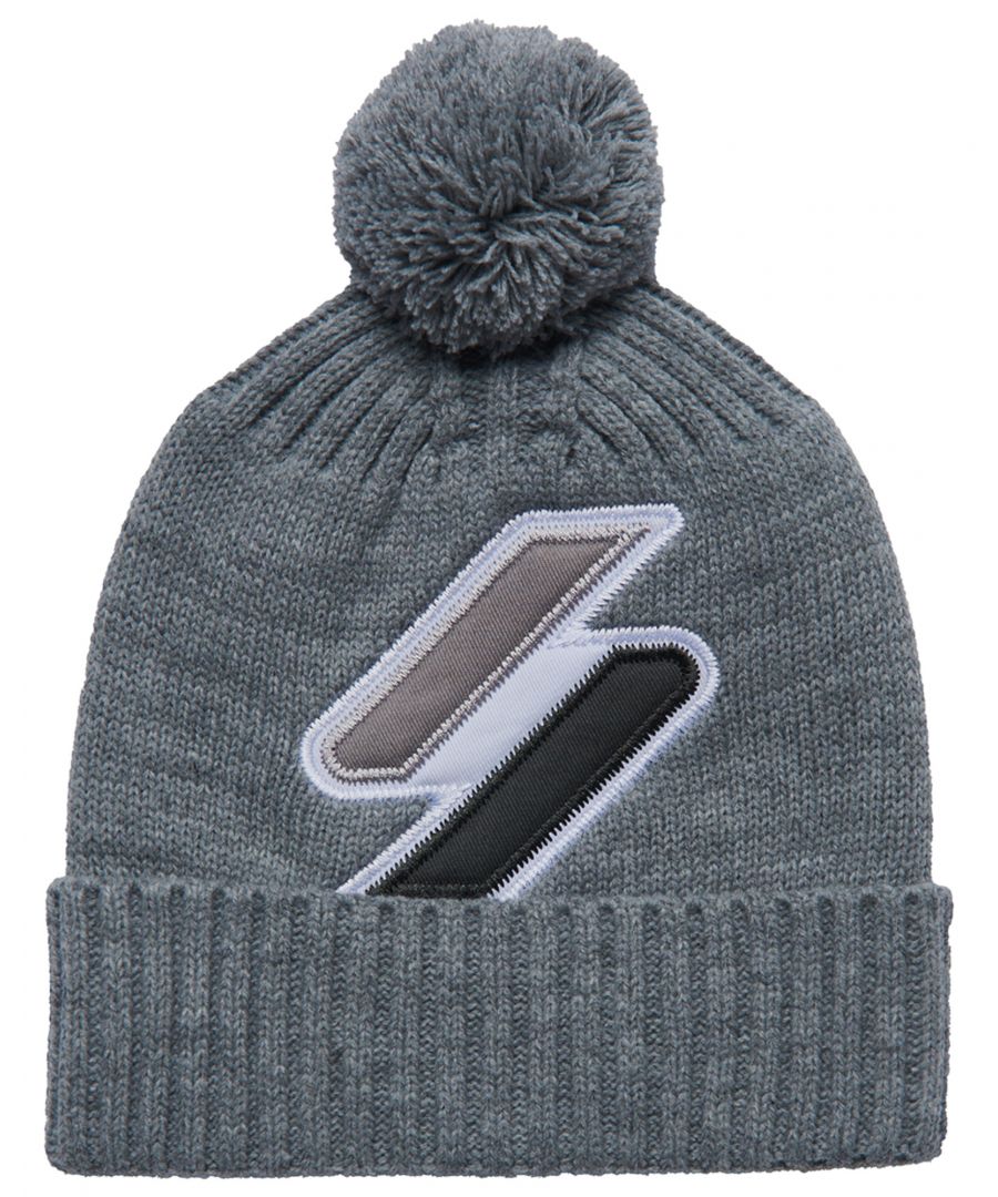 Stay warm, stylish, and part of the Superdry family with the Logo Beanie .Pom pom, Roll up hem.\nCable knit. Embroidered logo\nL x 37cm W x 22cm